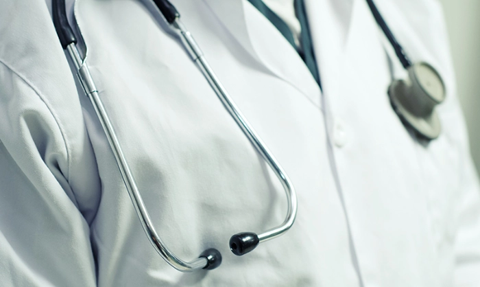 Doctor with stethoscope hanging around his neck.